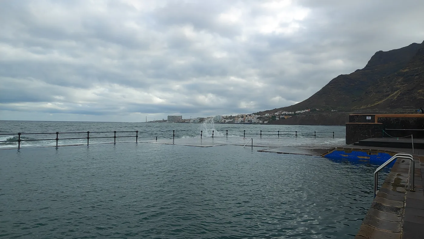 The natural seawater pools of Bajamar behind their dyke, Tenerife.