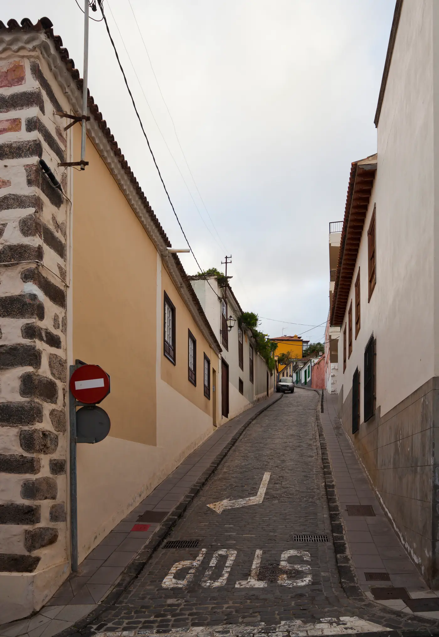 Steep cobbled Calle San Juan between traditional houses in La Orotava, Tenerife.