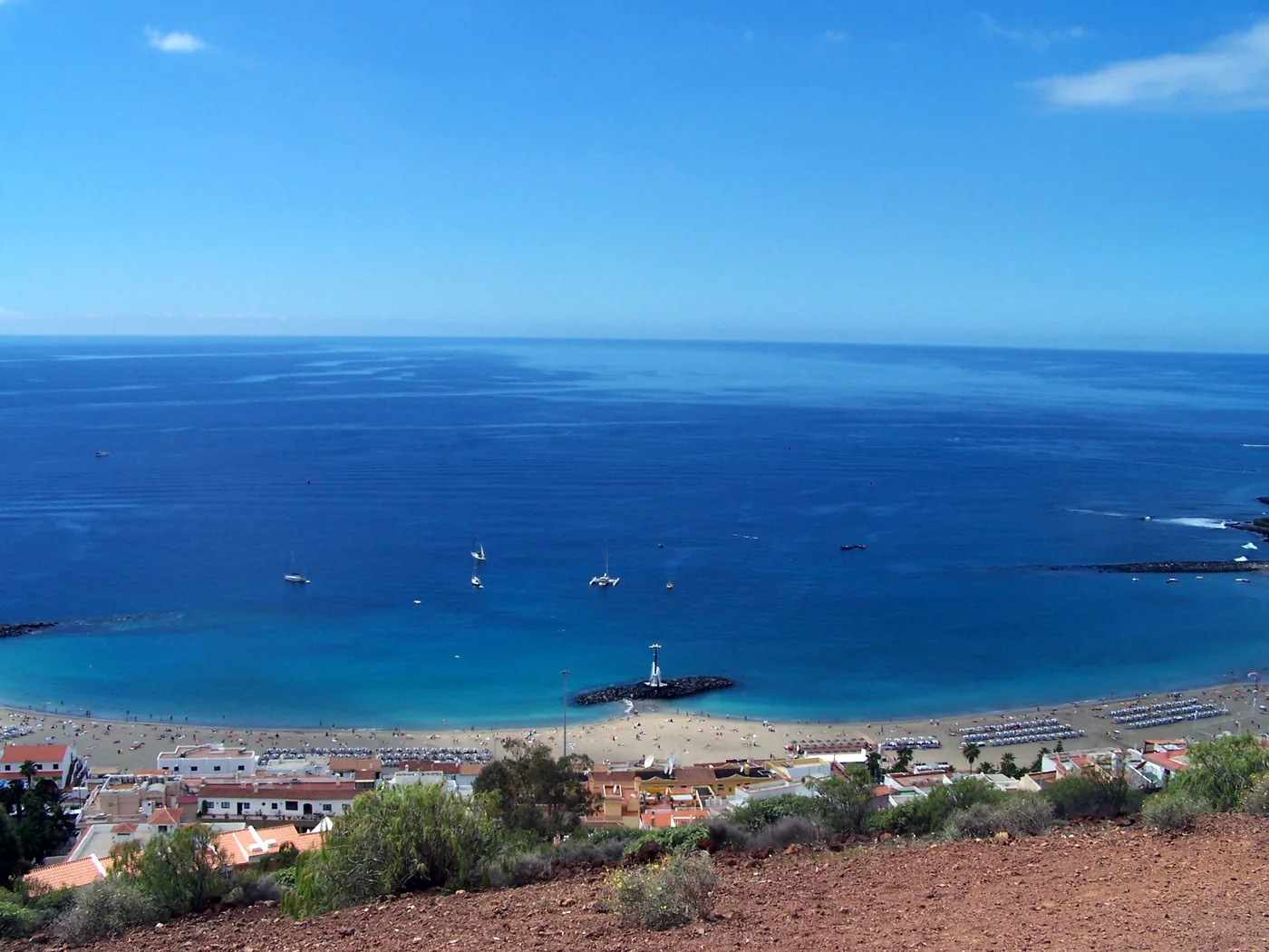The town beach of Los Cristianos, Tenerife, with the hills behind the bay.