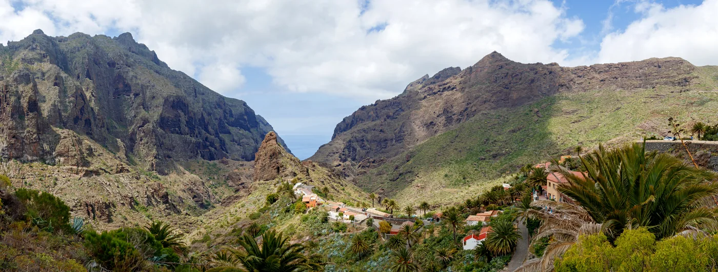 The Masca valley in the Teno massif, Tenerife: steep green ridges with houses on the slopes.