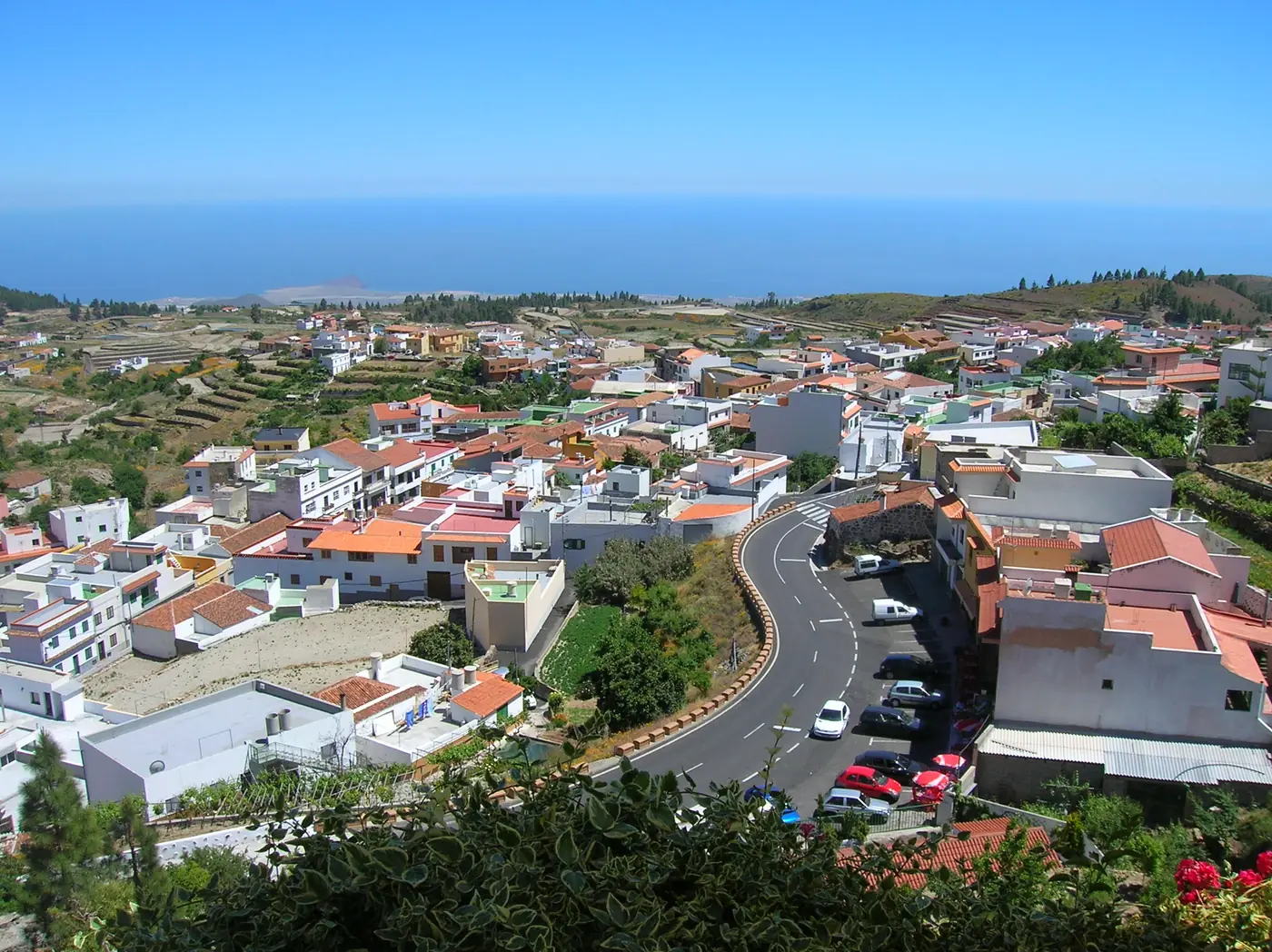 The white houses and streets of Vilaflor on the slope, with the sea far below, Tenerife.