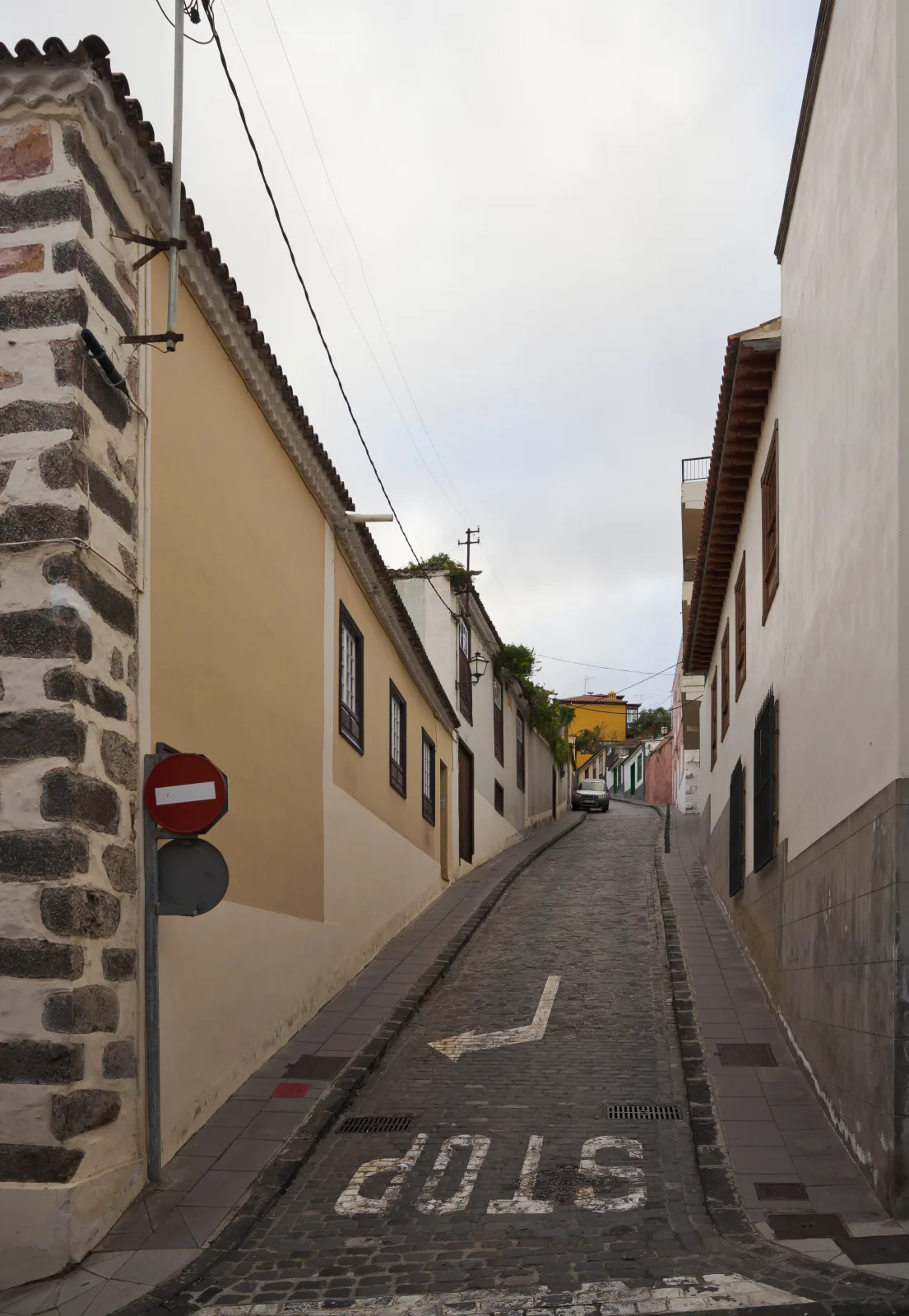 Steep cobbled Calle San Juan between traditional houses in La Orotava, Tenerife.